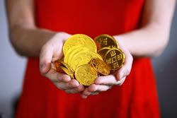woman holding gold coins