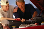 Father and son working on car