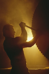 industrial worker adjusting a large gear