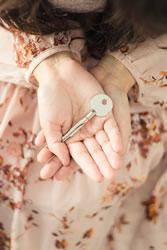 woman holding out a key of hope