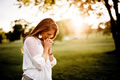woman praying in sunshine